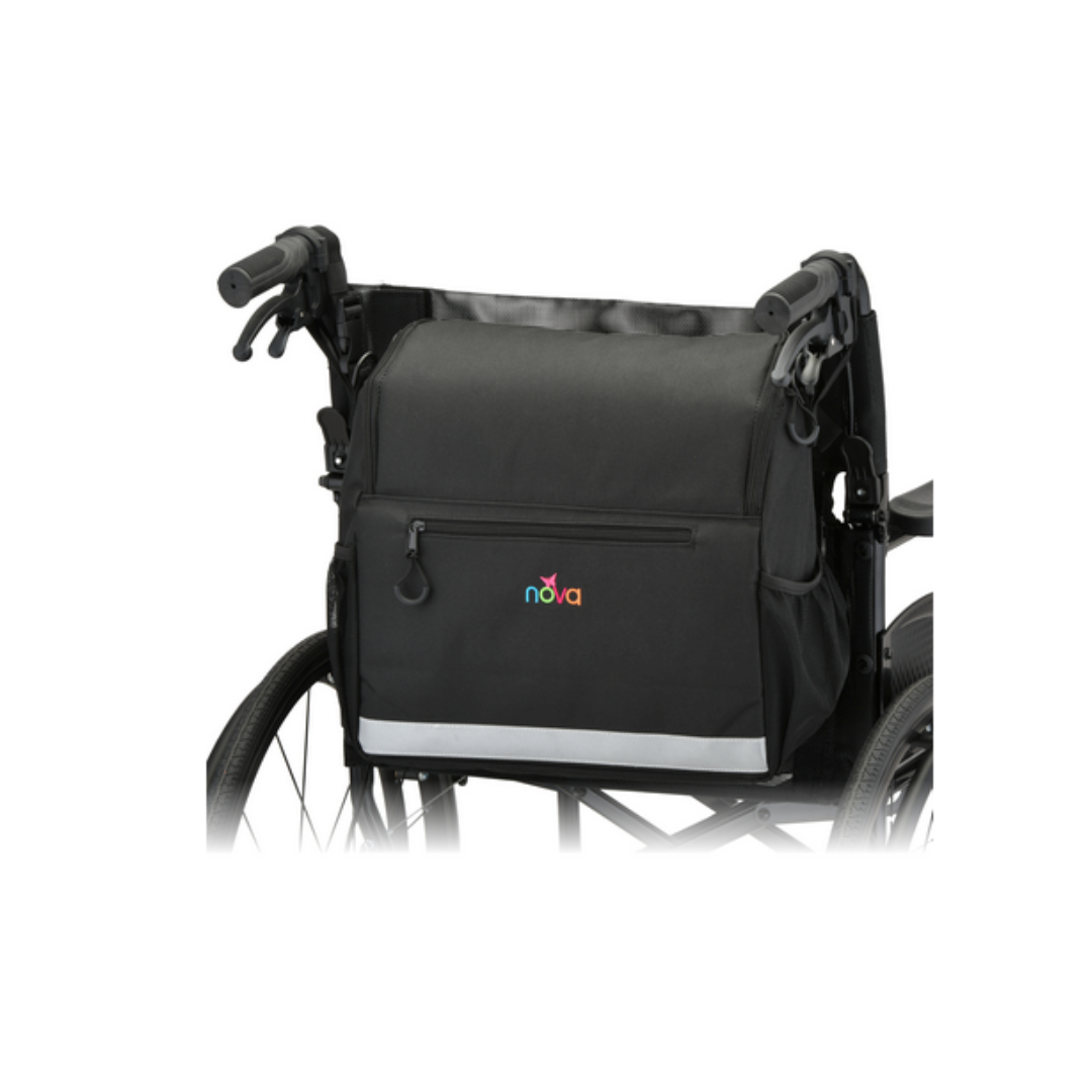 A black NOVA Wheelchair Bag with Cup Holder, a waterproof wheelchair accessory featuring a front zipper pocket, is attached to the back of a wheelchair, with handlebars and part of the wheels visible.
